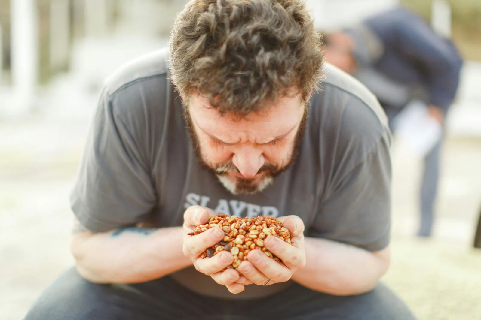 Jeff Taylor from PT's Coffee Roasting gets close to a dry processed coffee at Finca Los Planes.